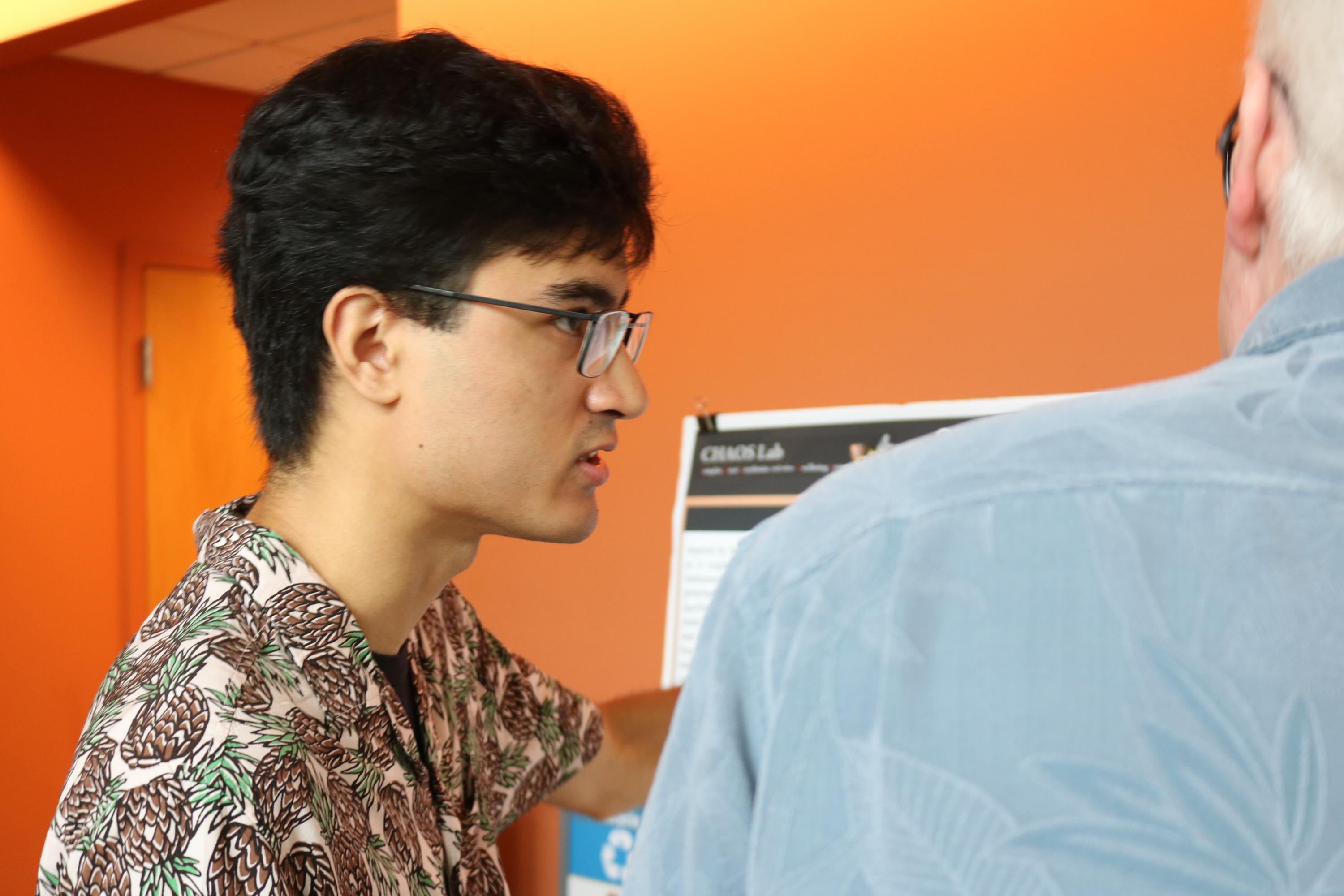 Brendan D'Aquino, rising senior at Northeastern University, explains his research during the summer 2022 School of Physics REU. (Photo Renay San Miguel)